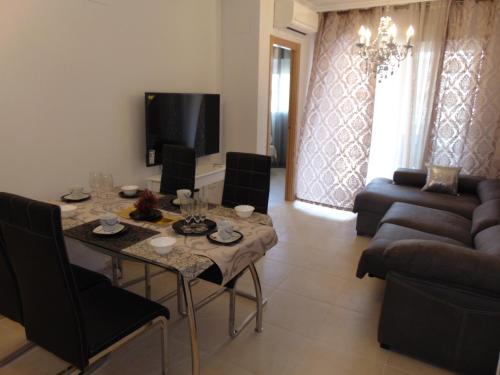 a living room with a table and a couch at Apartamentos varios con 2 dorm en Marina Dor , la playa de Amplaries 47 , vista lateral al mar in Oropesa del Mar