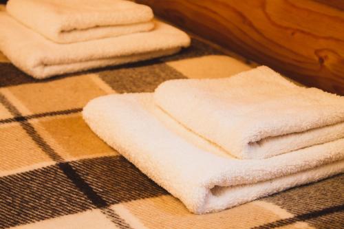 a pile of white towels sitting on the floor at Guest House Svitliza in Yaremche