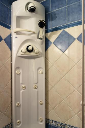 a shower door with two knobs on it in a bathroom at Casa Rural el Sastre in Navaleno