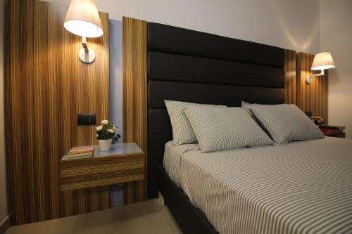 a bedroom with a large bed with a black headboard at Almare' B&b in Torre Santa Sabina