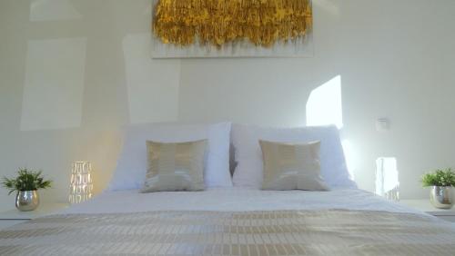 a bedroom with a bed with white sheets and pillows at Villa Anna - 4 bedrooms, 4 bathrooms, heated pool, jacuzzi in Kornić