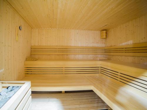 an empty sauna with wooden floors and ceilings at Lucky40 - Apartament z widokiem na morze, SPA gratis, Dwie Sosny in Ustronie Morskie