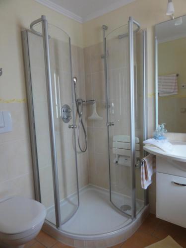 a bathroom with a shower and a toilet and a sink at Gastehaus Luise in Oberstdorf