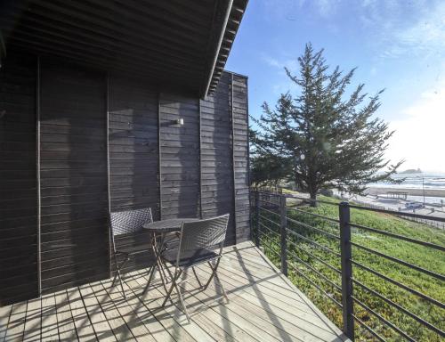 a patio with two chairs and a table on a deck at OMZ - Olas de Matanzas in Matanzas
