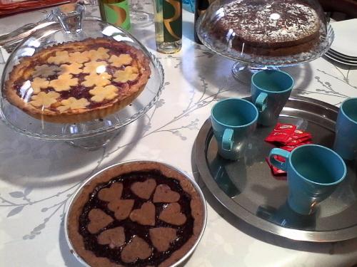a table with two cakes and a pie on it at LA CASA DEI MASUE' in Alba