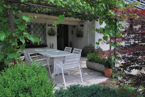 a patio area with a patio table and chairs at Rooms-Apartments Stojanovič in Bled