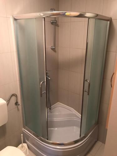 a shower with a glass door in a bathroom at Apartmani Dora in Vodice