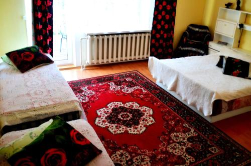 a living room with two beds and a rug at Roosi Holiday Home in Rannaküla