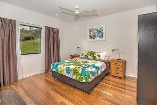 a bedroom with a bed and a dresser and a window at Eumundi Cottages - Cottage 1 in Eumundi