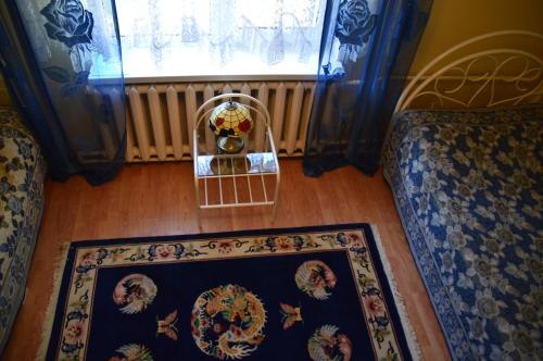 a room with two chairs and a rug and a window at Roosi Holiday Home in Rannaküla