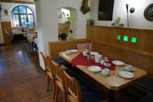a wooden table with plates and dishes on it at Bayerischer Hof in Burghausen