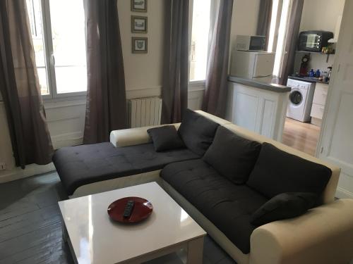 a living room with a couch and a coffee table at Appartement Aubusson in Aubusson