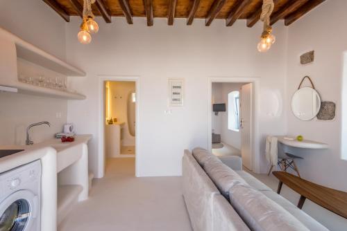 a living room with a couch and a washing machine at Plaka Suites in Plaka Milou