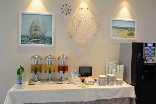 a table with plates and wine glasses on it at Kiara Residence in Giulianova
