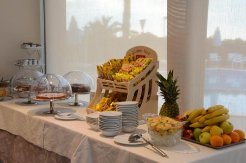a table with a buffet of food and fruit on it at Kiara Residence in Giulianova