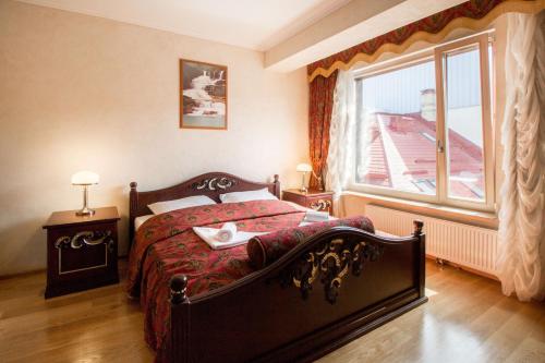 sypialnia z dużym łóżkiem i oknem w obiekcie Old Riga terrace apartment w Rydze