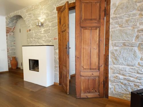 an open door in a room with a stone wall at Old Town Apartment in Tallinn