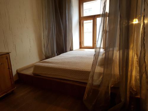 a small bedroom with a bed and a window at Old Town Apartment in Tallinn