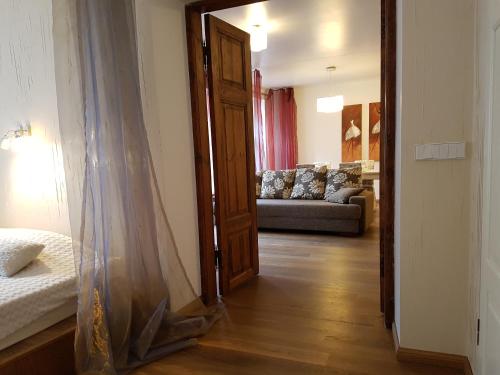 a bedroom with a bed and a living room with a couch at Old Town Apartment in Tallinn