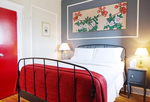 a bedroom with a bed with a red blanket at The Box House Hotel in Brooklyn