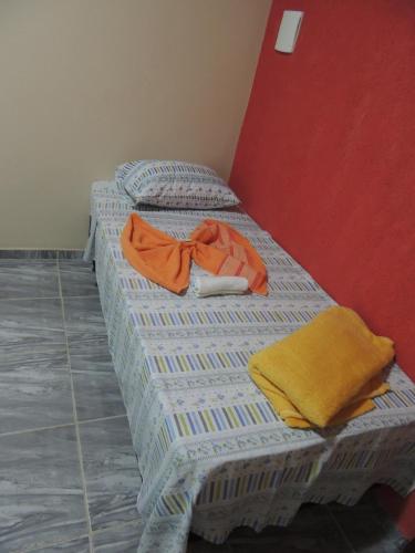 two twin beds with towels on them in a room at Pousada Centaurus in Alto Paraíso de Goiás