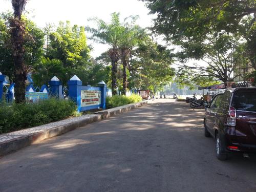 a car parked on the side of a street at Discovery Homestay in Makassar