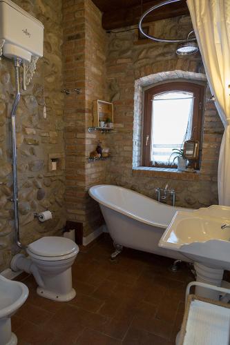a bathroom with a tub and a toilet and a sink at La Torre Medioevale in Marne di Filago