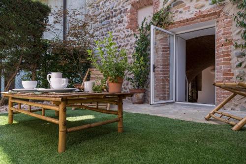 a wooden table sitting on grass in a garden at La Torre Medioevale in Marne di Filago