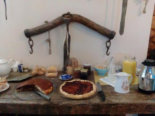 a table with a pie and some food on it at Antico Casale dei Sogni agriturismo in Lugo
