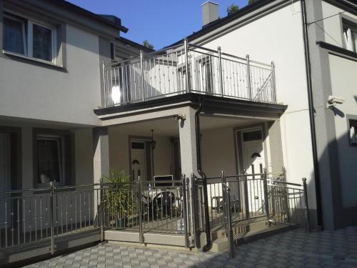 an apartment building with a balcony and a patio at Apartments Royal Menex in Požarevac