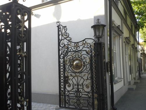 a black gate with a lamp on a street at Apartments Royal Menex in Požarevac
