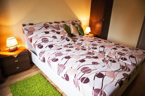 a bedroom with a bed with a brown and white comforter at Barnabáš Rusnák Ubytovanie v súkromí in Mučín