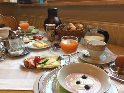 a table topped with plates of food and drinks at Haus Müller in Reutte