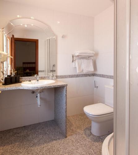a bathroom with a sink and a toilet and a mirror at Hotel Montana by Bossh! Hotels in Roses