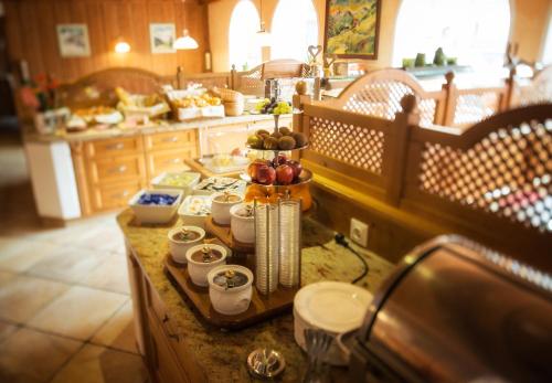 a kitchen with a counter with food on it at Hotel Augarten in Neustift im Stubaital