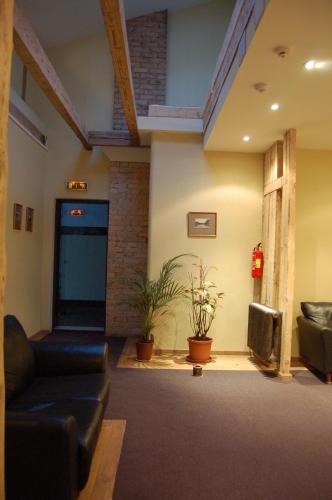 a living room with a couch and a building at Cafe Hotel Rudzons in Madona