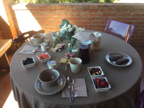 a table with a grey table cloth with food on it at Villa Niccoli in Castelfiorentino