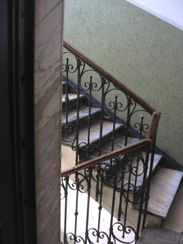 a flight of stairs with a mirror next to it at Stanza d'artista in Genova