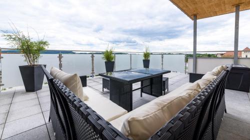 a patio area with chairs, tables, and tables at Penthouse Ferienwohnung Loft in Öhringen