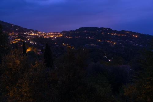 a view of a city at night at Logis Hôtel La Bellaudière in Grasse