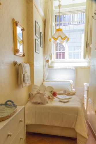 a small bedroom with a bed with a window at Casa Isabella B&B in Rocca San Giovanni