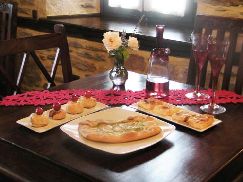 a wooden table with two plates of food on it at Iliopetra Suites in Agios Lavredios