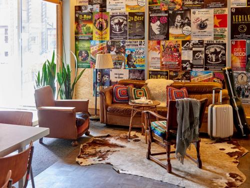 a living room with a couch and a table at Q-Factory Hotel in Amsterdam