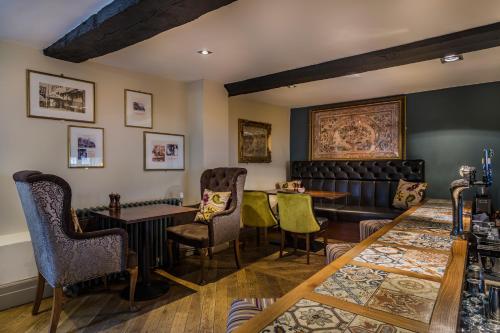 a living room with a couch and chairs at The Talbot Hotel, Oundle , Near Peterborough - The Coaching Inn Group in Oundle