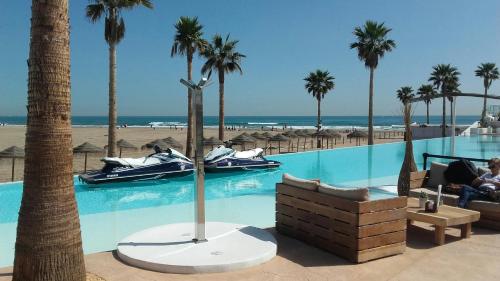 a resort with a swimming pool and palm trees at Apartamento Sofia in Valencia