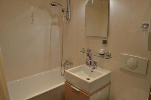 a bathroom with a sink and a shower at Apartament Irek 1000L PP in Międzyzdroje