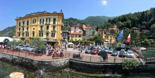 a group of people on a bridge over a body of water at Hotel Olivedo in Varenna