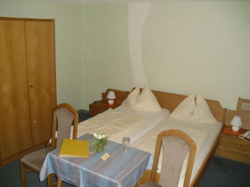 a room with a bed with a table and a laptop at Eisenerzer Hof in Eisenerz