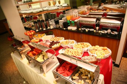 a buffet line with many different types of food at Sanare Hotel in Uberlândia