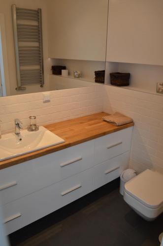 a bathroom with a sink and a toilet and a mirror at Horyzont 806 in Międzyzdroje